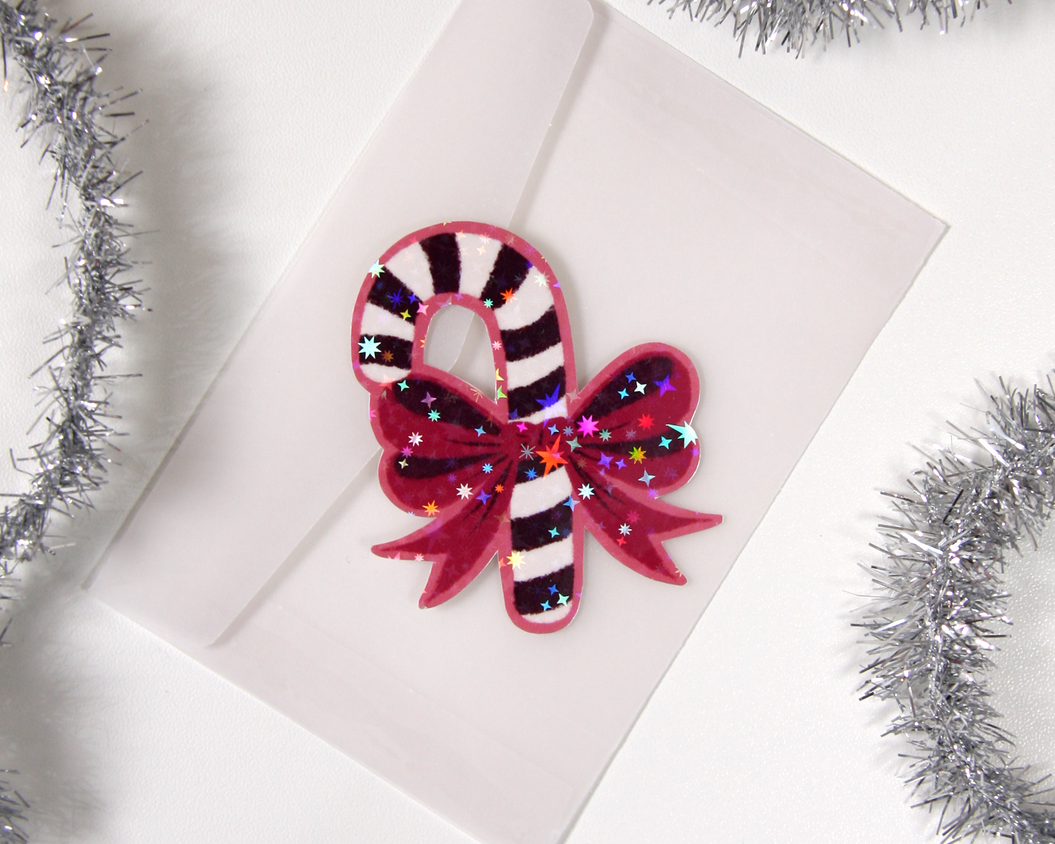 Glitzernder Weihnachtsaufkleber mit Zuckerstange & Schleife
