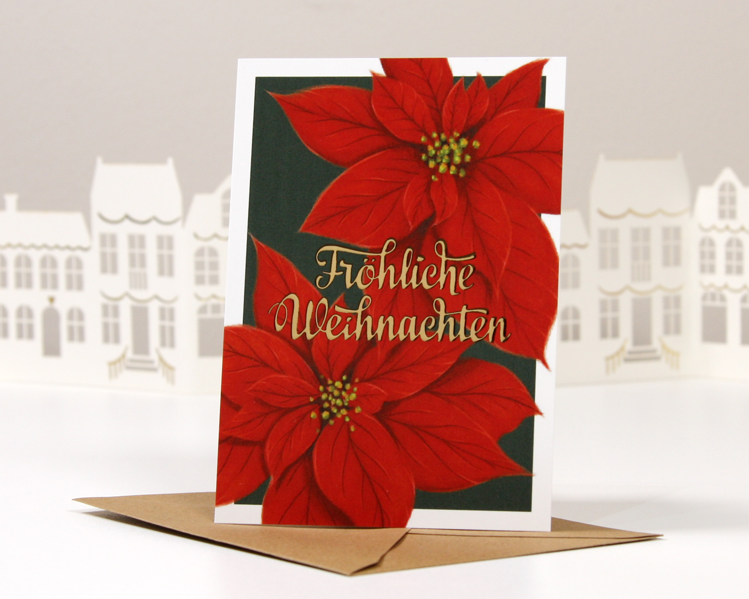 Hochwertige Weihnachtskarte "Fröhliche Weihnachten" mit goldener Heißfolienprägung und roten Weihnachtssternen